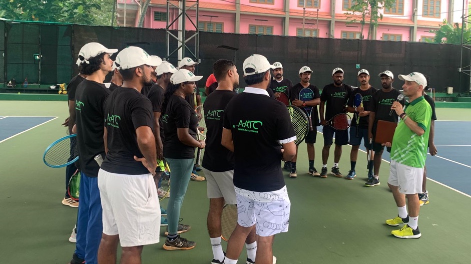 Coach speaking with a group of players during a club session